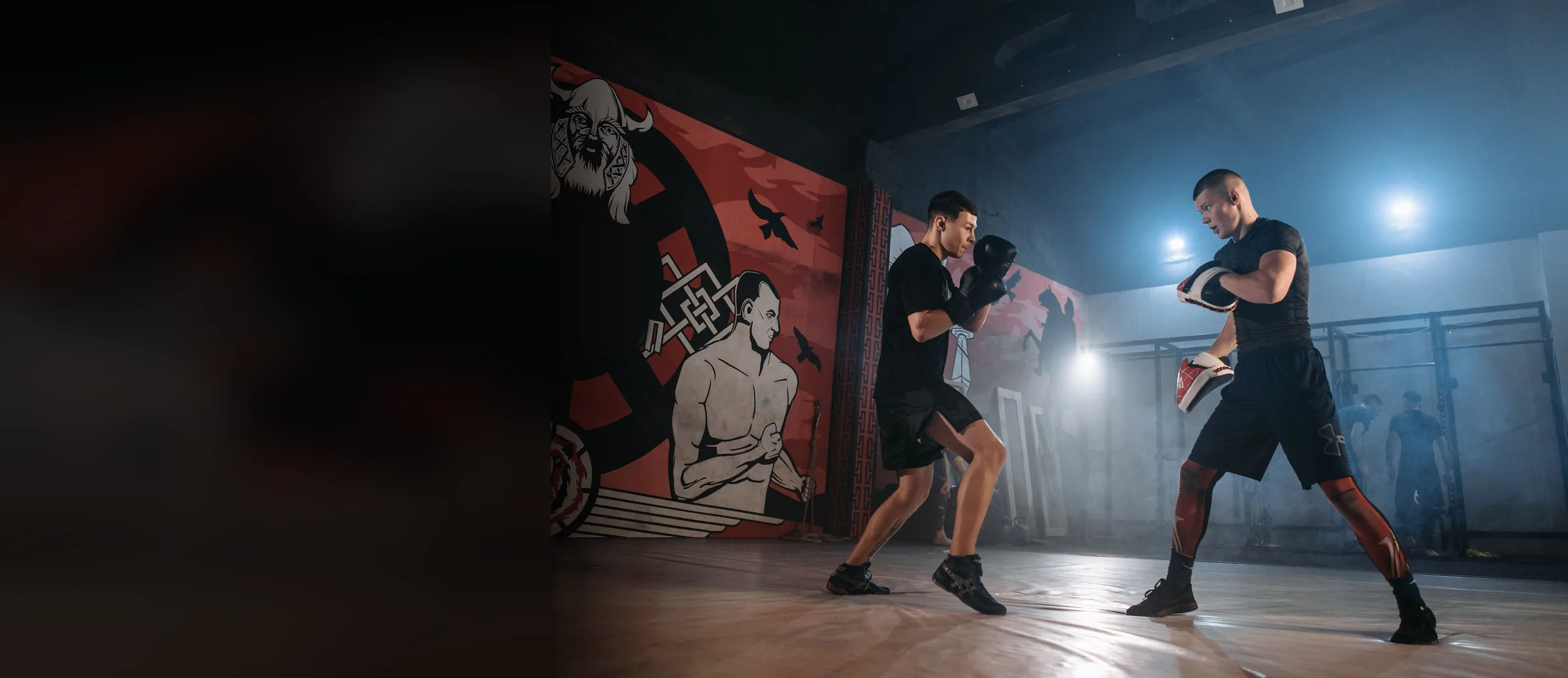 Two training partners working a round on focus mitts
